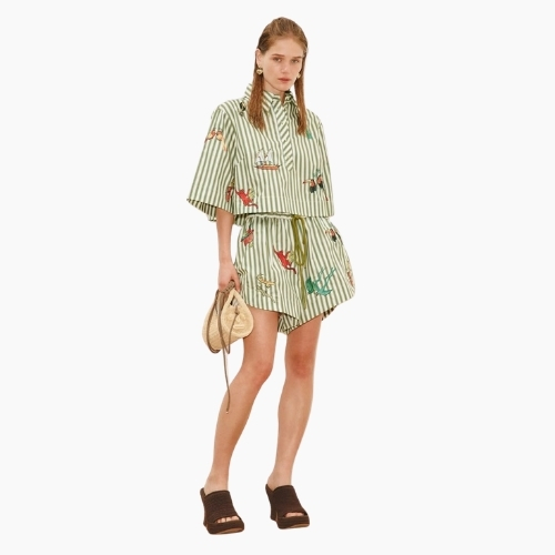 Green and white striped women’s co-ord set with cropped shirt, drawstring shorts and colourful animal and adventure motifs.